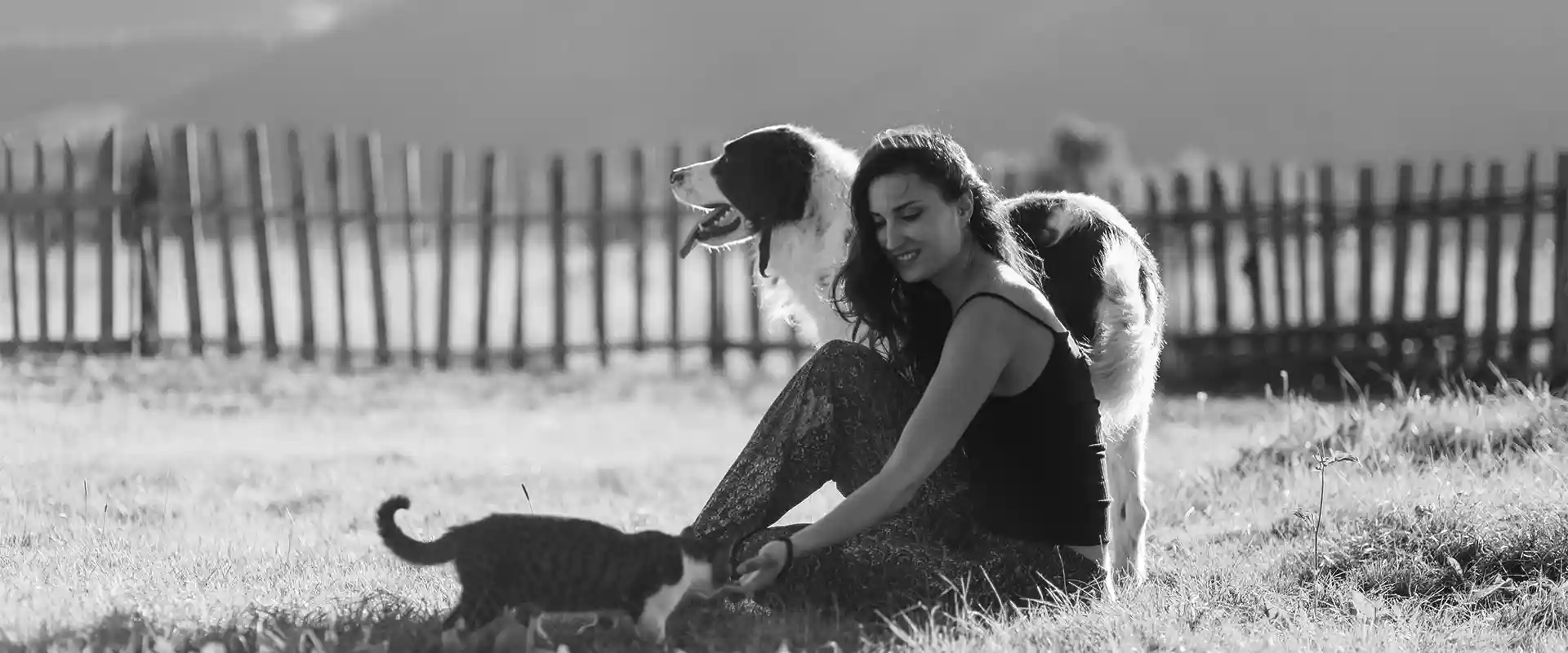 A woman with her pets outdoors